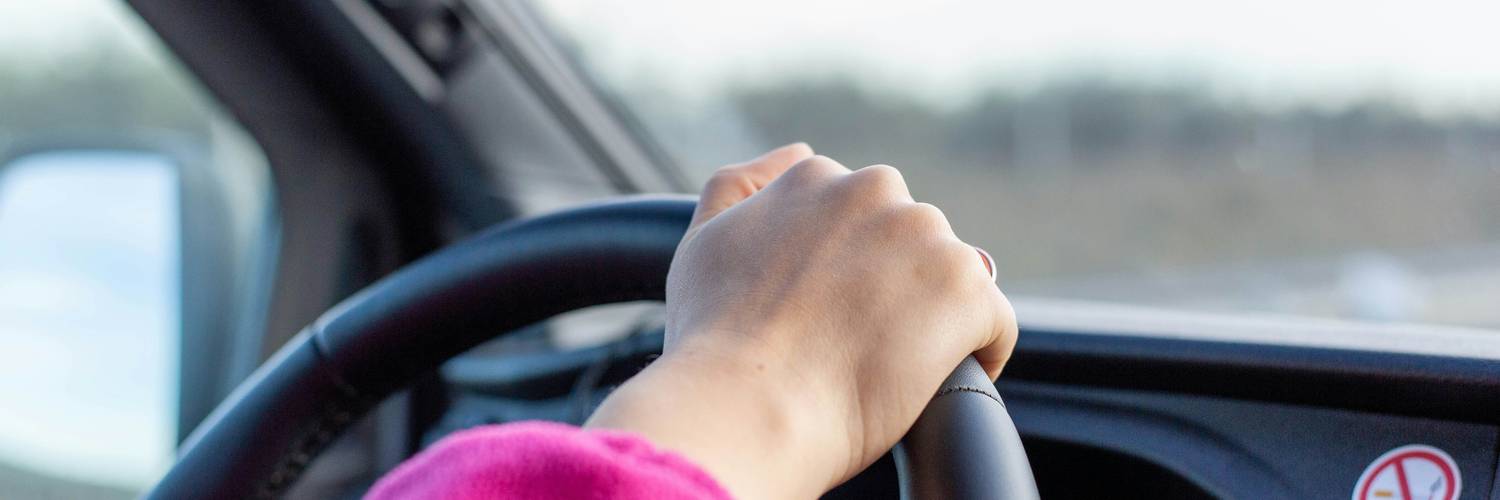 A new driver in Manitoba holding a learner's permit and driving with an instructor