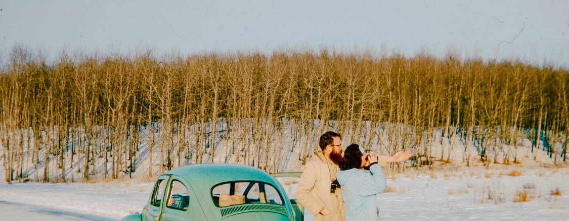 Couple exchanging keys after agreeing on a used-car sale in Manitoba